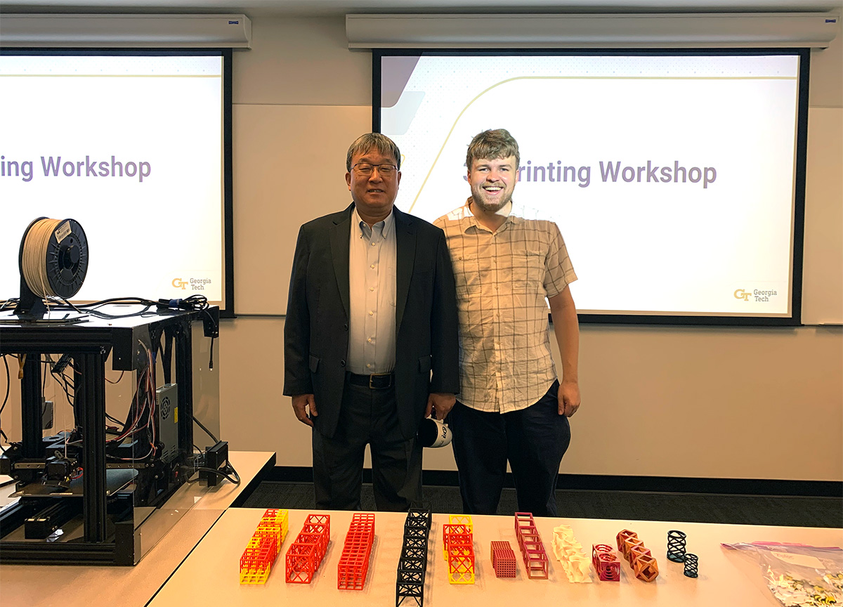 Photo by Michael Biehler. / Jianjun Shi (left) advises Michael Biehler (Ph.D. IE 2024) in a 3D printing workshop for K-12 students.