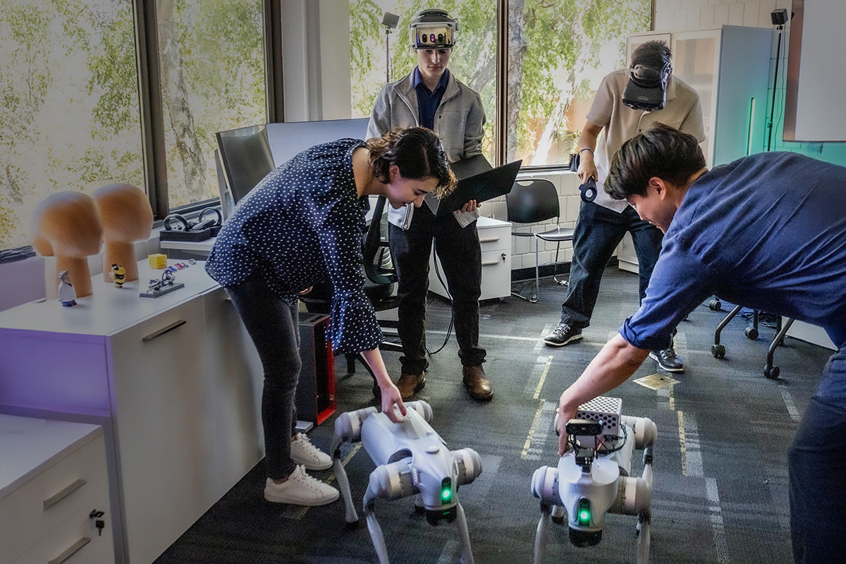 GT students working with VR XR headsets and robotic dogs