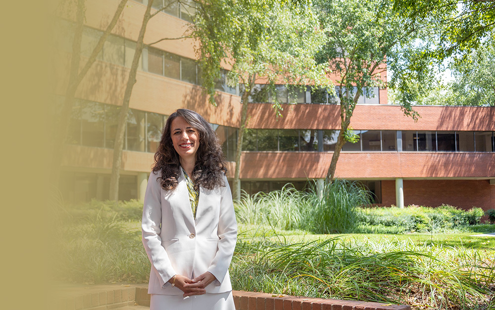 Pinar Keskinocak standing in the ISyE courtyard
