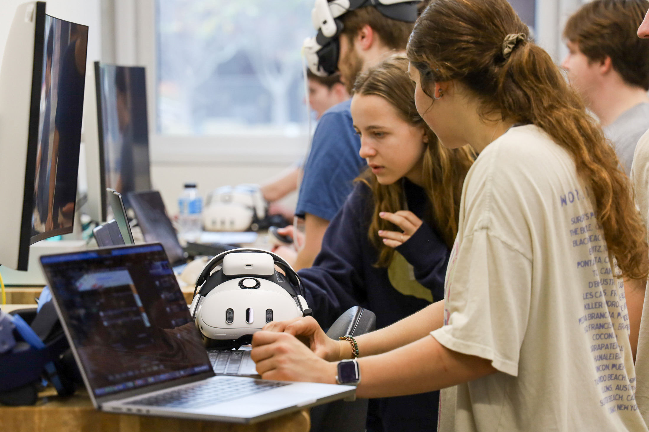 students working in a lab with comuters and vr headsets