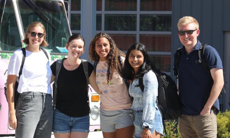 Students standing together smiling in a group