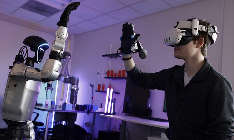 Student and Robot high fiving