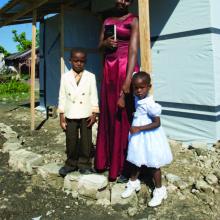Flore Charles and her children received a Habitat for Humanity transitional shelter.