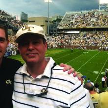 Matlock, IE 2011, and Ed Rogers, IE 1982, MS IL 2002, enjoying a Georgia Tech football game in 2012. Ed is a director of Global Strategy at UPS and Matlock works for Anheuser-Bush as a project manager.