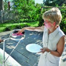 Valerie Thomas using her parabolic stove that uses the energy of the sun as fuel.